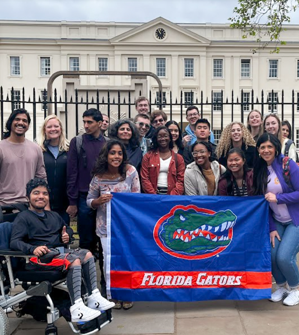Group photo of study abroad trip from 2023 holding a  Florida Gators flag